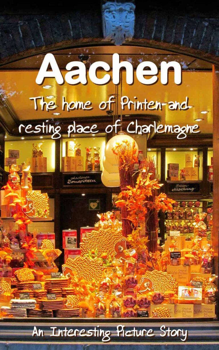 A night time picture through a brightly lit shop window displaying a variety of the Printen delicacy in various packaging that Aachen Germany is famous for.